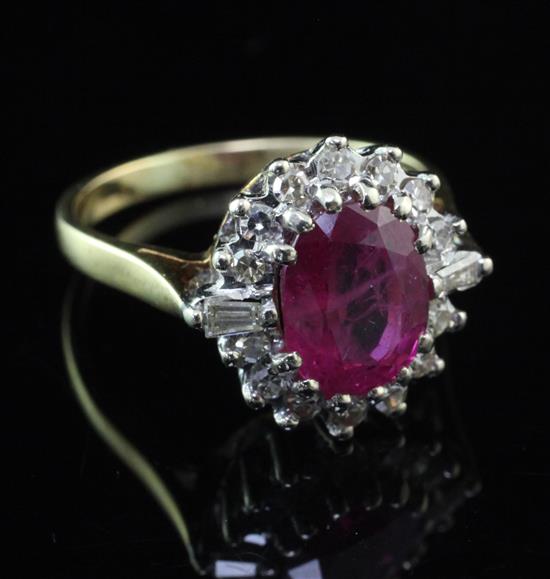 An 18ct gold, ruby and diamond oval cluster ring, size L.